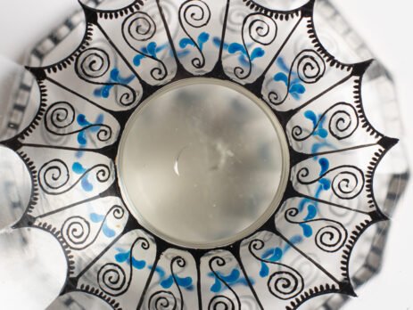 Bohemian Glass Compote, c. 1915, with hand-enamelled birds in scalloped blue panels, geometric glass cutting, gilt rim and a faceted foot decorated with black scrolls and blue leaves.