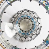 Bohemian Glass Compote, c. 1915, with hand-enamelled birds in scalloped blue panels, geometric glass cutting, gilt rim and a faceted foot decorated with black scrolls and blue leaves.