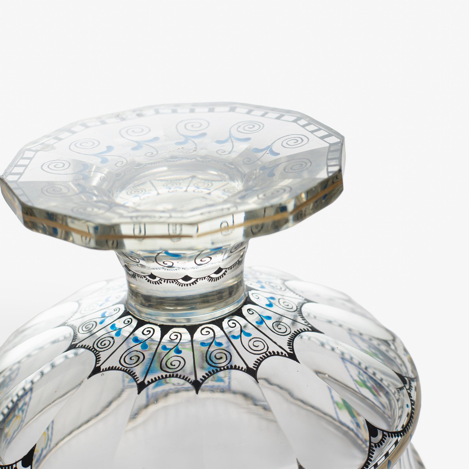 Bohemian Glass Compote, c. 1915, with hand-enamelled birds in scalloped blue panels, geometric glass cutting, gilt rim and a faceted foot decorated with black scrolls and blue leaves.